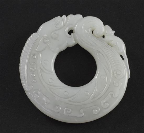 A Chinese archaistic white jade huang disc, 5.5cm